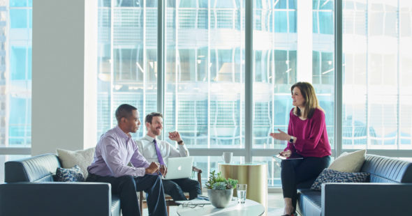 Business people having a conversation inside 71 South Wacker in Chicago, IL