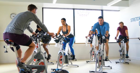 Group fitness class with an instructor on spin bikes at a KINETIC® Fitness Center