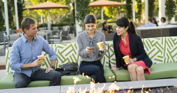 Photography of people enjoying The Commons, an outdoor workplace and gathering area, at 400 Spectrum Center Drive in Irvine, CA
