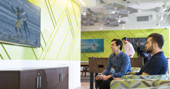 Photography of the customer lounge at Jamboree Center in Irvine, CA, where customers can enjoy foosball or the entertainment system with their coworkers and friends