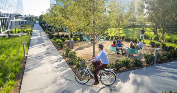 Photography of people enjoying The Commons, an outdoor workplace and gathering area, at The Quad at Discovery Park in Irvine, CA
