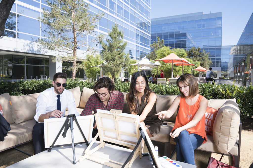 Photography of people enjoying The Commons, an outdoor workplace and gathering area, at Santa Clara Square in Santa Clara, CA