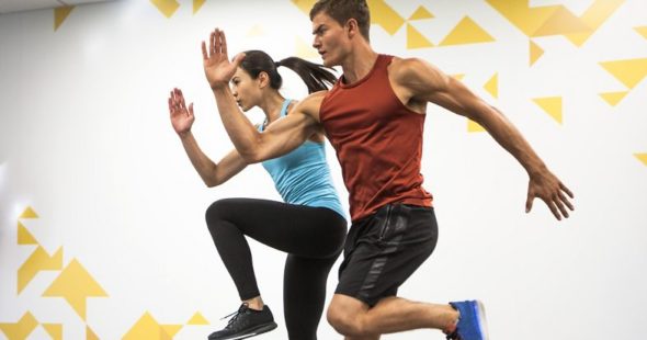 A man and woman exercising at a KINETIC® Fitness Center