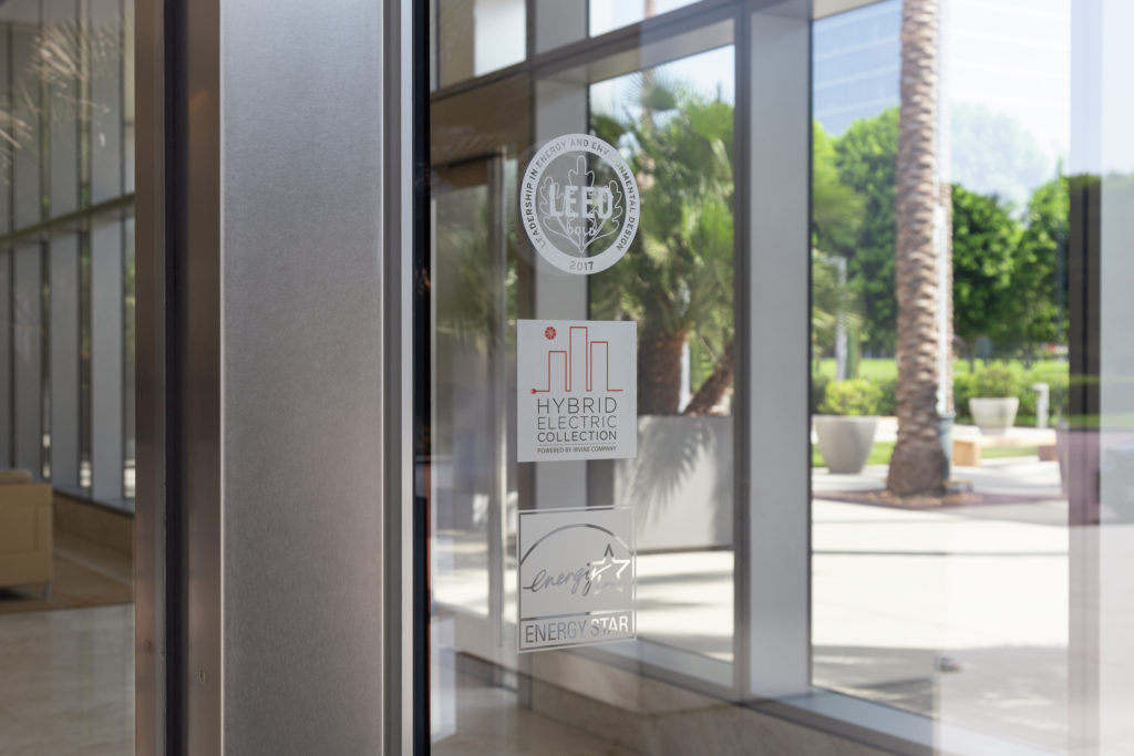 Sustainability etched glass logos of LEED and Energy Star certifications as well as the Hybrid Electric Collection program at Irvine Company Office properties