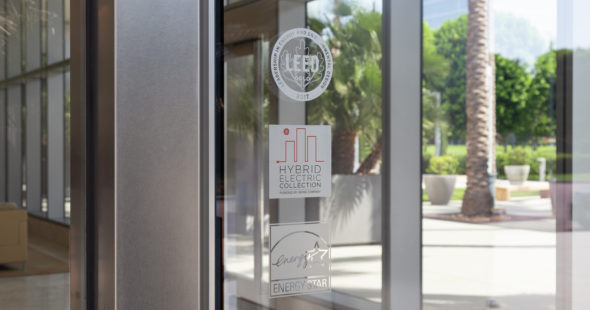Sustainability etched glass logos of LEED and Energy Star certifications as well as the Hybrid Electric Collection program at Irvine Company Office properties