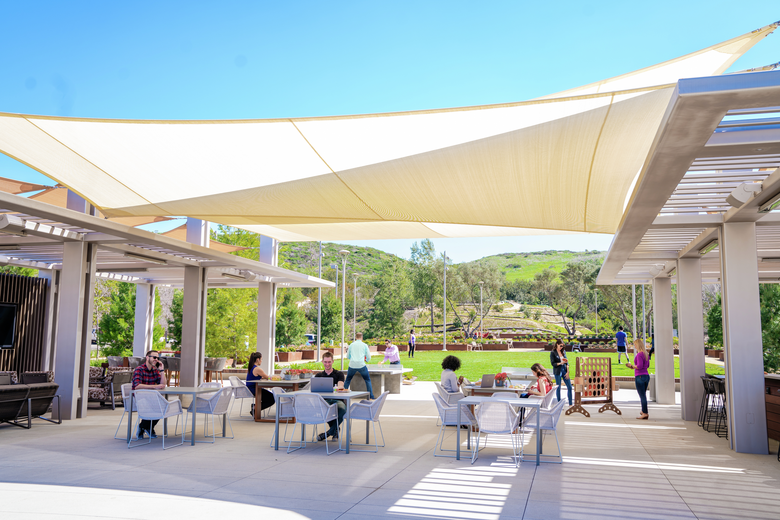 Photography of people enjoying The Commons, an outdoor workplace and gathering area, at UCI Research Park in Irvine, CA